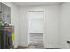 A small laundry room with a water heater and doorway to another room at 4608 Deltona Blvd, Spring Hill, FL 34606