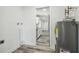 Small laundry area with water heater next to the door to the kitchen area at 4608 Deltona Blvd, Spring Hill, FL 34606