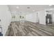 Spacious living area with modern hardwood floors and natural light, creating an open and inviting atmosphere at 4608 Deltona Blvd, Spring Hill, FL 34606