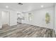 Bright and spacious living area featuring modern flooring and an inviting atmosphere, perfect for gatherings and relaxation at 4608 Deltona Blvd, Spring Hill, FL 34606