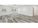 Bright living room with wood-style flooring and access to outdoors at 4608 Deltona Blvd, Spring Hill, FL 34606