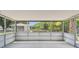 View of the screened-in porch overlooking the lush backyard at 4608 Deltona Blvd, Spring Hill, FL 34606
