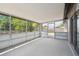 Screened-in porch featuring ample sunlight and access to the backyard at 4608 Deltona Blvd, Spring Hill, FL 34606