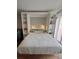 Comfortable Murphy bed with built-in shelving on both sides, adorned with decorative items and lighting at 51 Island Way # 309, Clearwater Beach, FL 33767