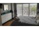 Bedroom with a queen-sized bed, dresser, hardwood floors, and a bright view from the window at 51 Island Way # 309, Clearwater Beach, FL 33767