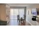 Dining area featuring a round table with four chairs and a view of the sliding glass doors at 51 Island Way # 309, Clearwater Beach, FL 33767