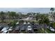 A parking lot filled with cars, surrounded by lush trees and city buildings in the background at 51 Island Way # 309, Clearwater Beach, FL 33767
