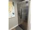 Stainless steel refrigerator with water dispenser, next to a decorative painting on the wall at 51 Island Way # 309, Clearwater Beach, FL 33767