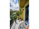 Balcony area with small outdoor table, lush foliage, and a view of the neighborhood at 5529 White Marlin Ct, New Port Richey, FL 34652