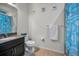 Well-lit bathroom featuring a granite countertop, matching cabinetry, and coastal themed decor at 5529 White Marlin Ct, New Port Richey, FL 34652