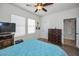 Comfortable bedroom showcasing neutral walls, a ceiling fan and two bright, sunny windows at 5529 White Marlin Ct, New Port Richey, FL 34652