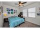 Cozy bedroom featuring a ceiling fan and a bright window for a cheerful ambiance at 5529 White Marlin Ct, New Port Richey, FL 34652