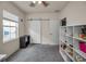 Bright bedroom featuring neutral tones, a sliding barn door, and window bringing in natural light at 5529 White Marlin Ct, New Port Richey, FL 34652