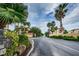 A manicured neighborhood entrance with palm trees and well-maintained landscaping at 5529 White Marlin Ct, New Port Richey, FL 34652
