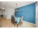 Modern dining room featuring a blue accent wall and contemporary lighting at 5529 White Marlin Ct, New Port Richey, FL 34652
