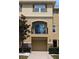 Townhouse with a second-story balcony, a garage, and well-maintained landscaping at 5529 White Marlin Ct, New Port Richey, FL 34652