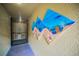 Hallway with beach-themed artwork and a gate leading to a storage area at 5529 White Marlin Ct, New Port Richey, FL 34652