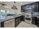 Contemporary kitchen featuring stainless steel appliances, a granite countertop island, and modern fixtures at 5529 White Marlin Ct, New Port Richey, FL 34652