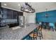 Open kitchen with granite countertops, an island with bar seating, and stainless steel appliances at 5529 White Marlin Ct, New Port Richey, FL 34652
