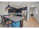 Modern kitchen with a granite countertop island, stainless steel appliances, and stylish backsplash at 5529 White Marlin Ct, New Port Richey, FL 34652