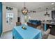 Open-concept living area with a comfortable blue sectional, dining area, and a balcony view at 5529 White Marlin Ct, New Port Richey, FL 34652
