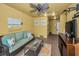 Cozy living room including turtle decor, a ceiling fan, and a television at 5529 White Marlin Ct, New Port Richey, FL 34652