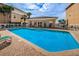 Community pool with lounge chairs and tables, ideal for relaxation and socializing at 5529 White Marlin Ct, New Port Richey, FL 34652