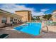 Community pool with lounge chairs and tables, ideal for relaxation and socializing at 5529 White Marlin Ct, New Port Richey, FL 34652