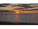 Beautiful sunset reflecting across a tranquil seascape with a sandy beach shoreline at 5529 White Marlin Ct, New Port Richey, FL 34652