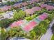 Overhead view of tennis courts nestled in a residential community with tree-lined streets and parking at 5705 Baywater Dr # 5705, Tampa, FL 33615