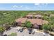 Aerial view of apartment buildings with well-maintained roofs and ample parking surrounded by mature trees at 5705 Baywater Dr # 5705, Tampa, FL 33615