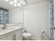 This cozy bathroom includes a shower and tub, white vanity, and bright lighting at 5705 Baywater Dr # 5705, Tampa, FL 33615