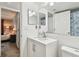 This updated bathroom has modern lighting, a white vanity, and a walk-in shower at 5705 Baywater Dr # 5705, Tampa, FL 33615