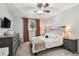 This bright bedroom features carpet flooring, a ceiling fan, and modern décor at 5705 Baywater Dr # 5705, Tampa, FL 33615