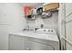 Clean laundry room featuring a washer, dryer, and storage shelf above at 5705 Baywater Dr # 5705, Tampa, FL 33615