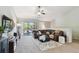 Cozy living room with vaulted ceilings, plush sectional sofa, large TV, ceiling fan, and balcony access at 5705 Baywater Dr # 5705, Tampa, FL 33615