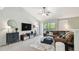 Bright living room with vaulted ceilings, plush sectional sofa, large TV, ceiling fan, and balcony access at 5705 Baywater Dr # 5705, Tampa, FL 33615