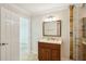 Bathroom features a wooden vanity with granite countertops and a glass enclosed shower at 6212 N Grady Ave, Tampa, FL 33614