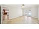 Bright bedroom features tile flooring, white walls, and an open entry to the kitchen at 6212 N Grady Ave, Tampa, FL 33614