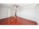 This bedroom features hardwood floors, a ceiling fan, and access to other rooms in the house at 6212 N Grady Ave, Tampa, FL 33614
