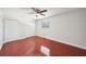 This bedroom features hardwood floors, a ceiling fan, a window, and two white door closets at 6212 N Grady Ave, Tampa, FL 33614