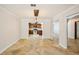 Open dining room featuring tile floors, white walls, and view into the kitchen at 6212 N Grady Ave, Tampa, FL 33614