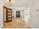 Welcoming foyer with travertine tile, decorative columns, and ample natural light shining through doorway at 6212 N Grady Ave, Tampa, FL 33614