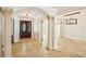 Elegant foyer boasts beautiful tile flooring, decorative columns, and an inviting archway to adjacent living spaces at 6212 N Grady Ave, Tampa, FL 33614