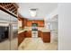 Stylish kitchen featuring granite countertops, wood cabinets, and stainless steel appliances at 6212 N Grady Ave, Tampa, FL 33614