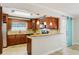 Kitchen features stone countertops, wood cabinets, stainless appliances, and a bar at 6212 N Grady Ave, Tampa, FL 33614