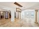 Elegant living area with travertine flooring, stylish lighting, and archways connecting various spaces at 6212 N Grady Ave, Tampa, FL 33614