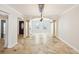 Spacious living room with travertine flooring, designer lighting, archways, and classic decorative columns at 6212 N Grady Ave, Tampa, FL 33614