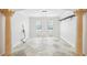 Bright living room featuring marble floors, white walls and architectural columns at 6212 N Grady Ave, Tampa, FL 33614
