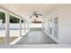 Covered patio with tile flooring, ceiling fans, and views of the spacious backyard through glass doors at 6212 N Grady Ave, Tampa, FL 33614